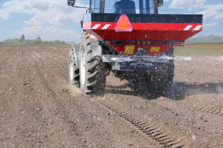 Spreading,mineral,fertilizer.,farmer,with,agricultural,machinery,fertilizing,agricultural,field